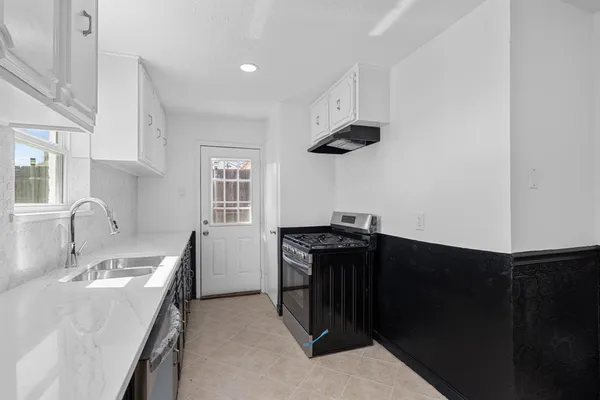a kitchen with a sink and a stove