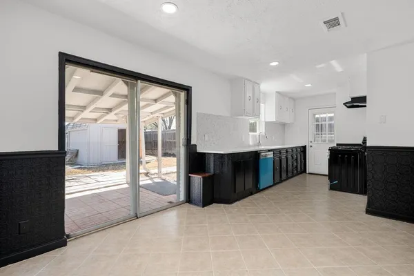 a large room with kitchen island granite countertop a large counter top and stainless steel appliances