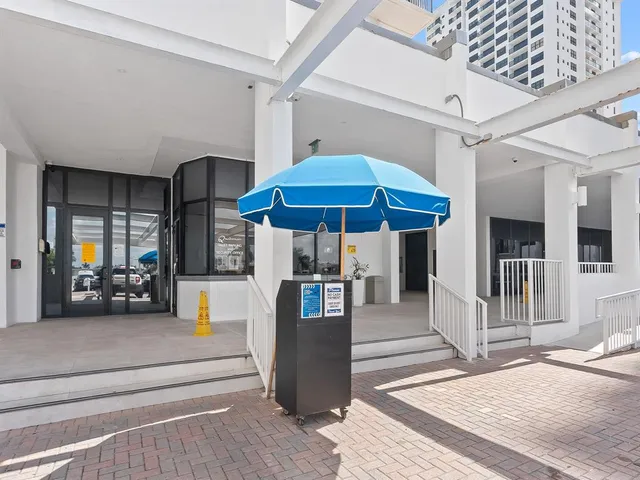 a living room with furniture and potted plants