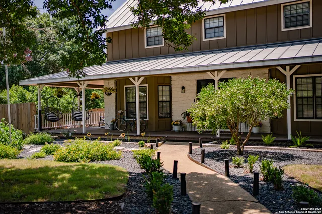 a view of a house with sitting area and garden