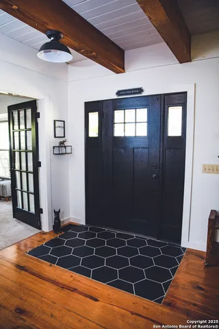 a view of a livingroom with wooden floor and door