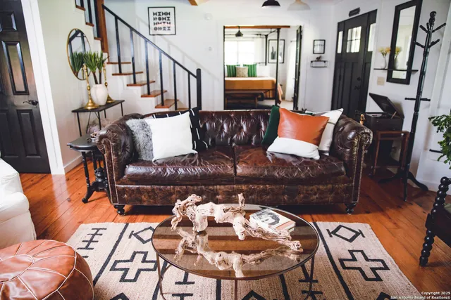 a living room with furniture and wooden floor