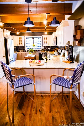 a kitchen with stainless steel appliances a stove a sink dishwasher and cabinets with wooden floor