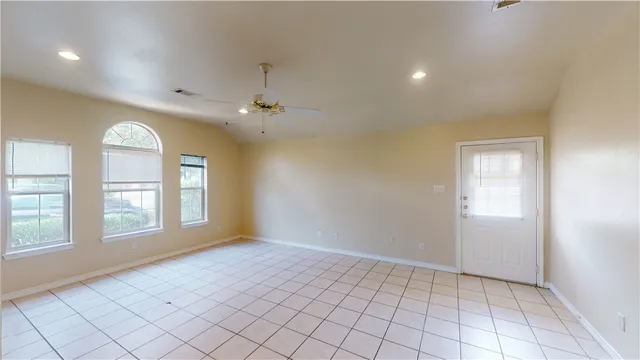 an empty room with windows and closet