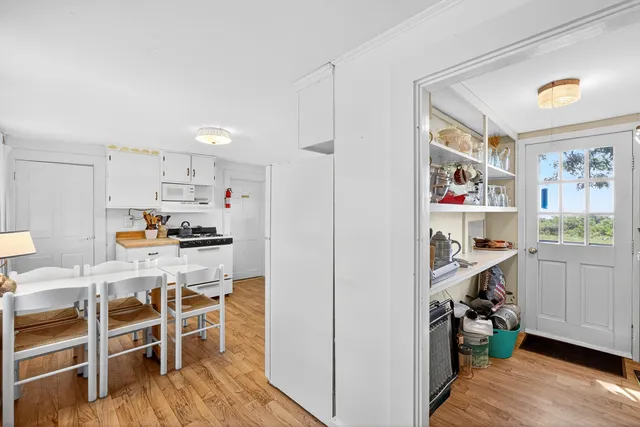 a kitchen with stainless steel appliances kitchen island granite countertop a refrigerator and cabinets