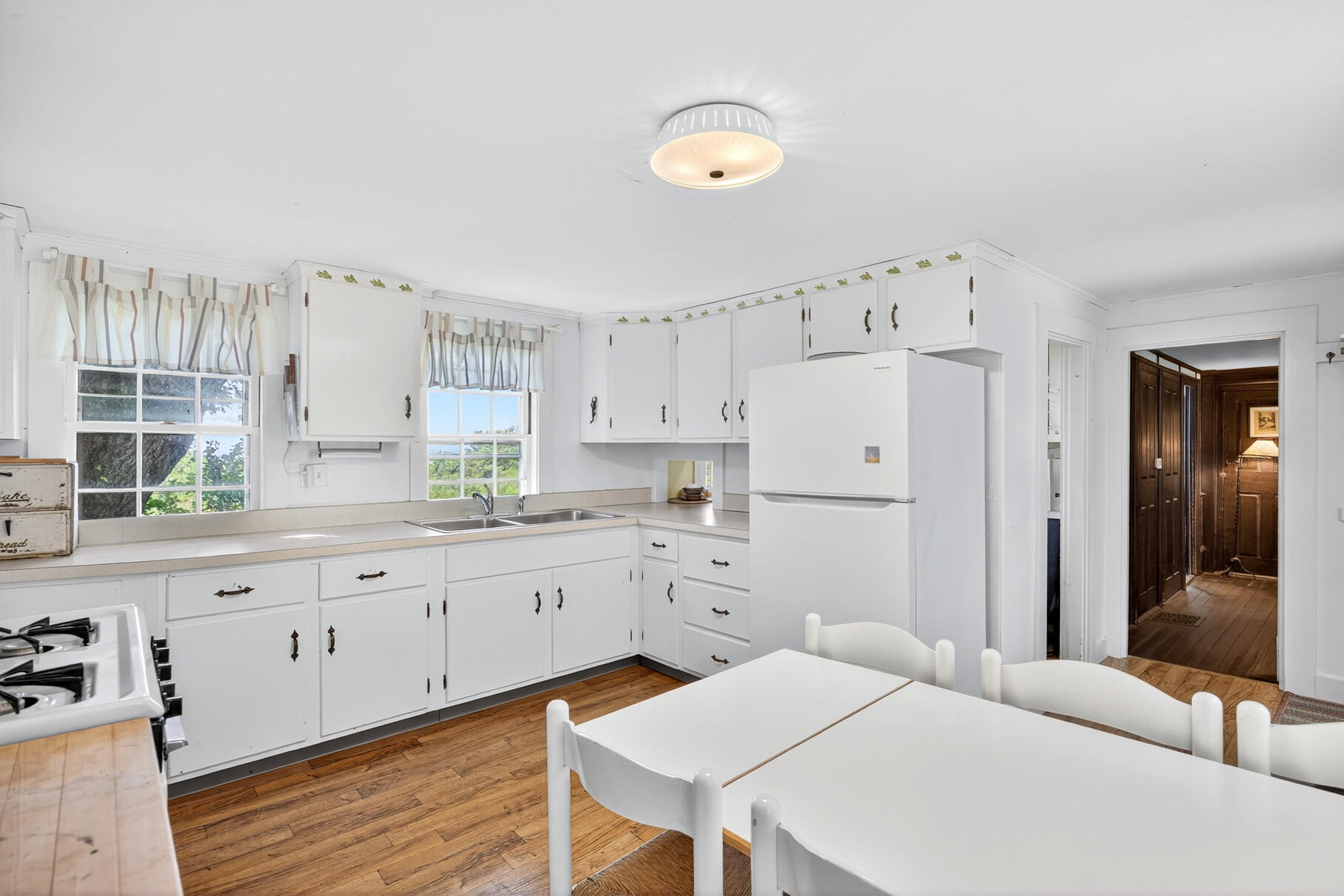10 Cartway South Eastham, MA 02642 - Photo 17 of 52 a large white kitchen with stainless steel appliances granite countertop a stove a sink a refrigerator and white cabinets with wooden floor