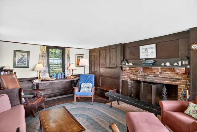 a living room with furniture a fireplace and window
