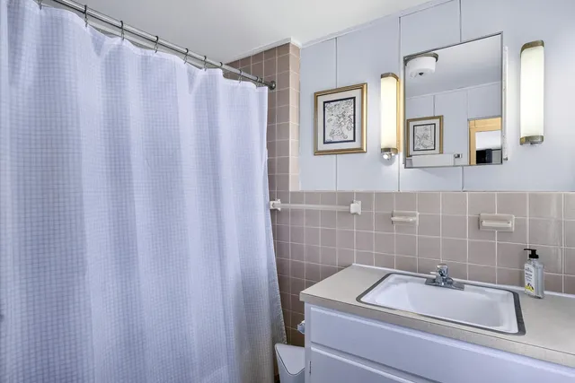 a bathroom with a sink and shower