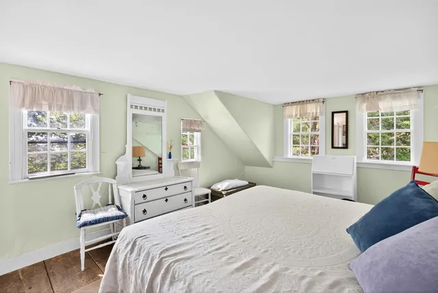 a bedroom with a bed and a chair