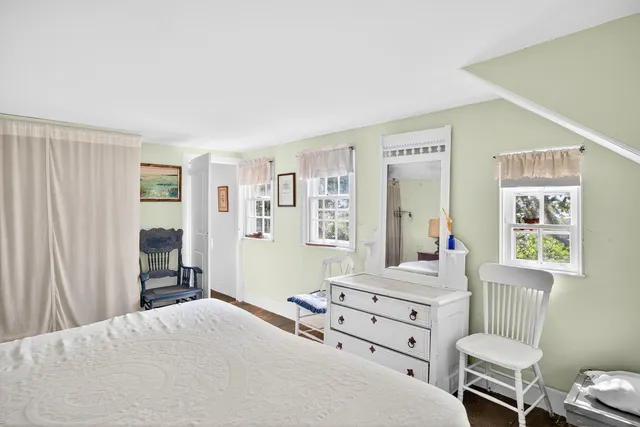 a bedroom with a bed and the view of en suite bathroom