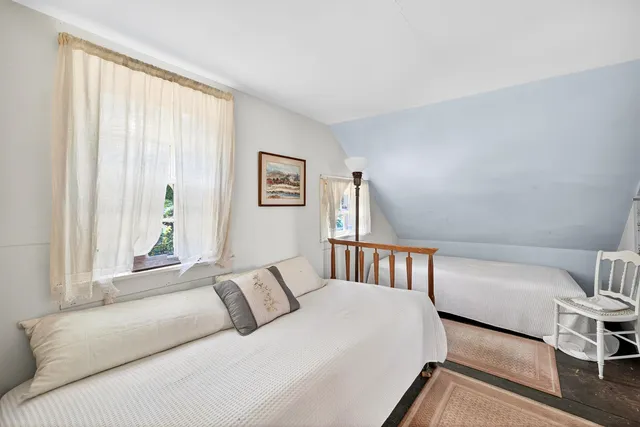 a bedroom with a large bed and a large window