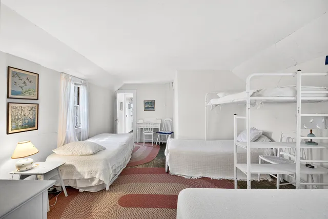 a bedroom with a bed and a lamp with window