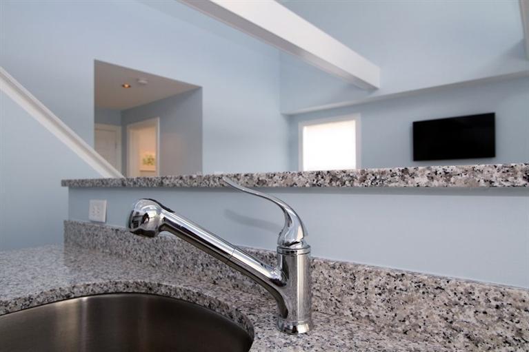 61 Old Wharf Road, Unit 1 Dennis Port, MA 02639 - Photo 11 of 34 a bathroom with a granite countertop sink and a mirror
