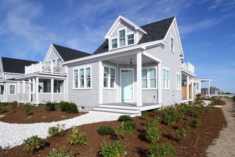 61 Old Wharf Road, Unit 1 Dennis Port, MA 02639 - Photo 3 of 34 a front view of a house with a yard