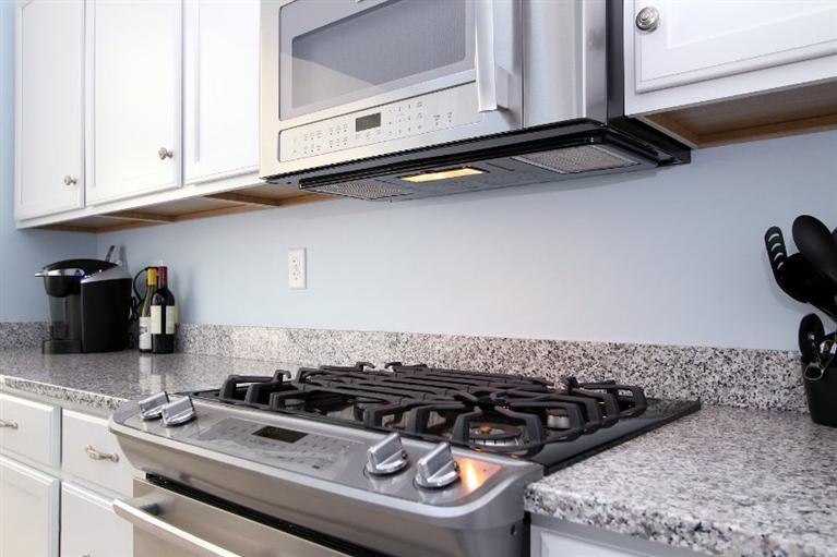 61 Old Wharf Road, Unit 1 Dennis Port, MA 02639 - Photo 10 of 34 a stove top oven sitting inside of a kitchen