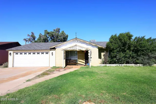a view of a house with a yard and garage
