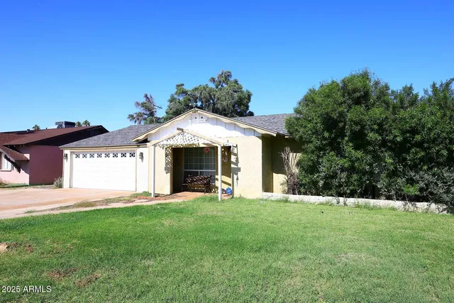 a view of a house with a yard and garage