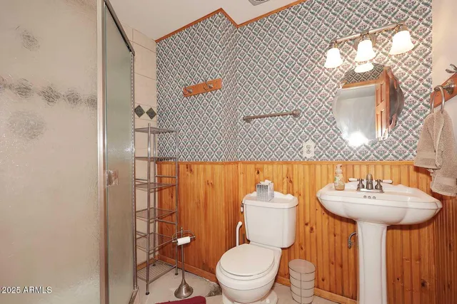 a bathroom with a sink toilet and a mirror