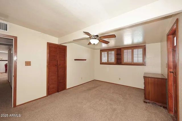 a view of a livingroom with a ceiling fan and window