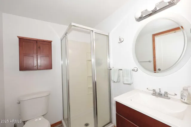 a bathroom with a sink mirror vanity and toilet