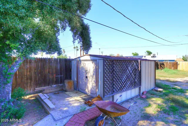 a view of a backyard with wooden fence