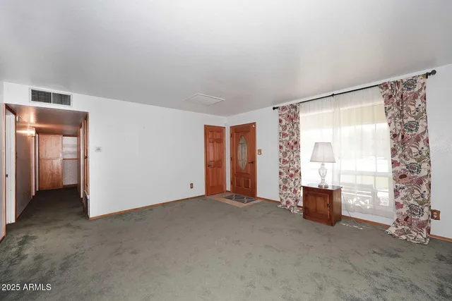 a view of an empty room with a window