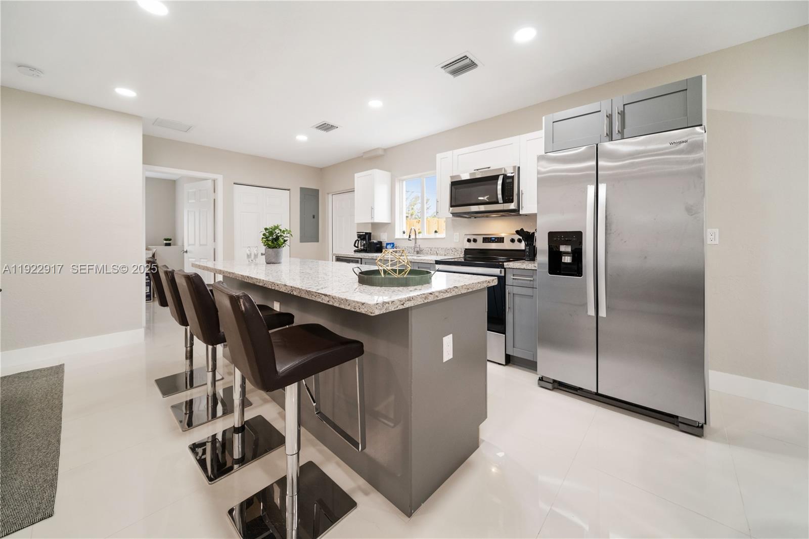 1770 Northwest 55th Street Miami, FL 33142 - Photo 11 of 21 a kitchen with kitchen island a counter top space stainless steel appliances and cabinets