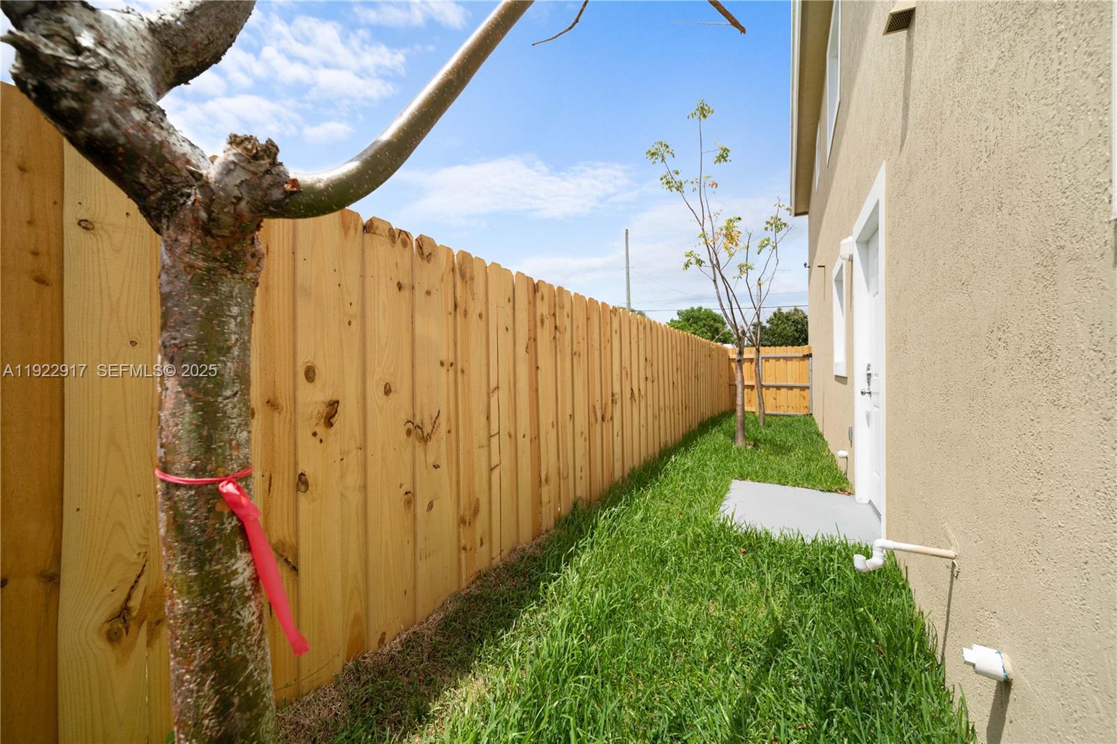 1770 Northwest 55th Street Miami, FL 33142 - Photo 5 of 21 a view of a pathway of a building with wooden fence