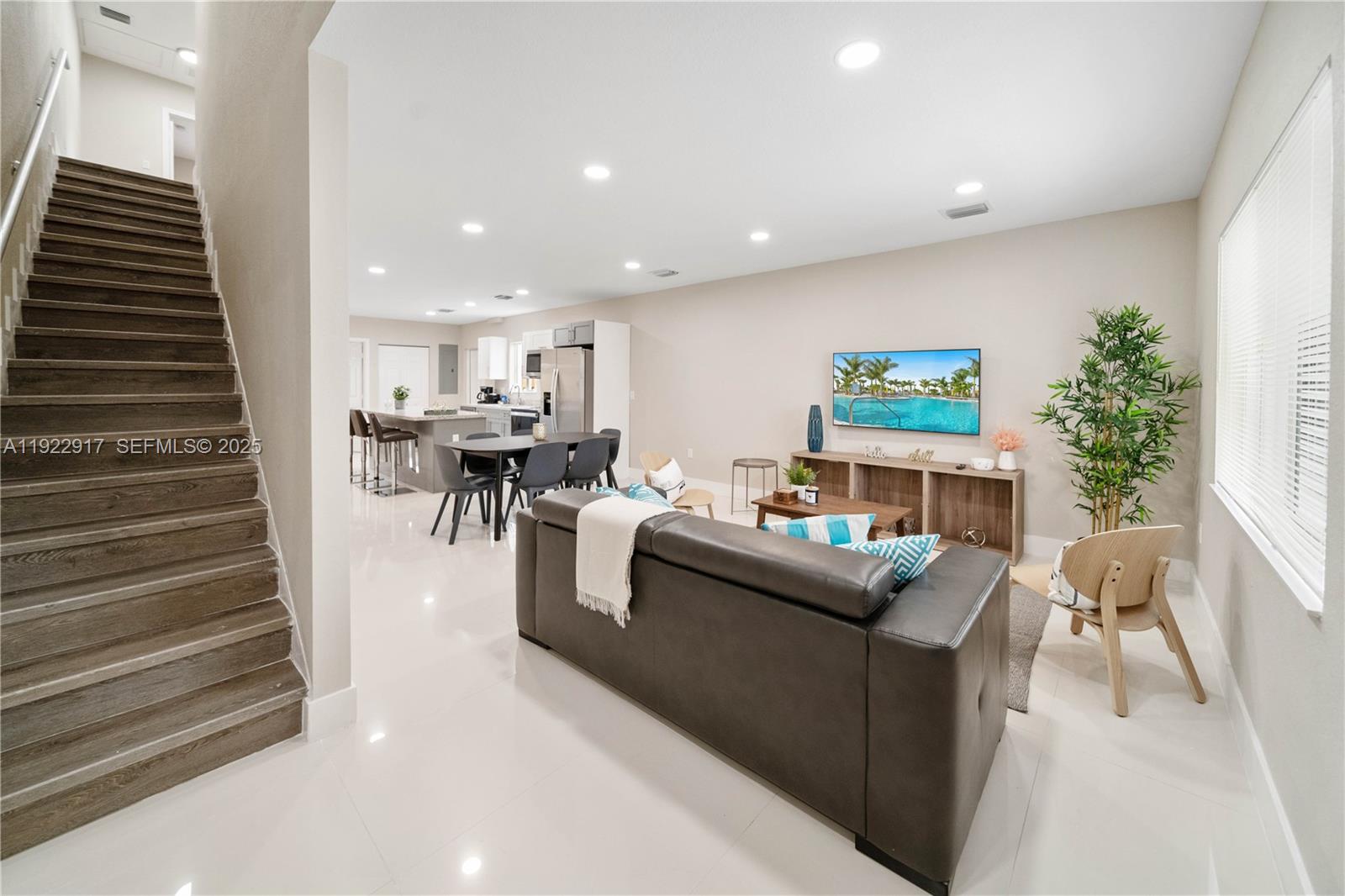 1770 Northwest 55th Street Miami, FL 33142 - Photo 6 of 21 a living room with furniture and a fireplace