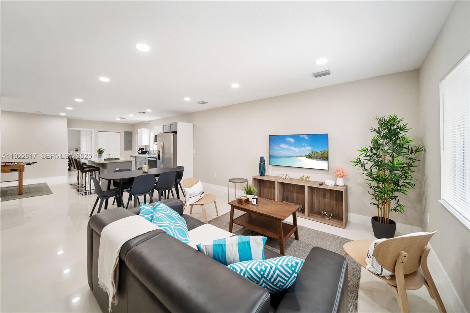 1770 Northwest 55th Street Miami, FL 33142 - Photo 7 of 21 a living room with furniture a glass table and a potted plant
