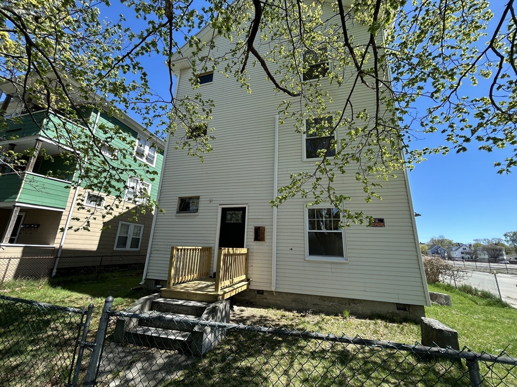 2 Stevens Road Worcester, MA 01603 - Photo 2 of 3 a flower garden is sitting in front of a house