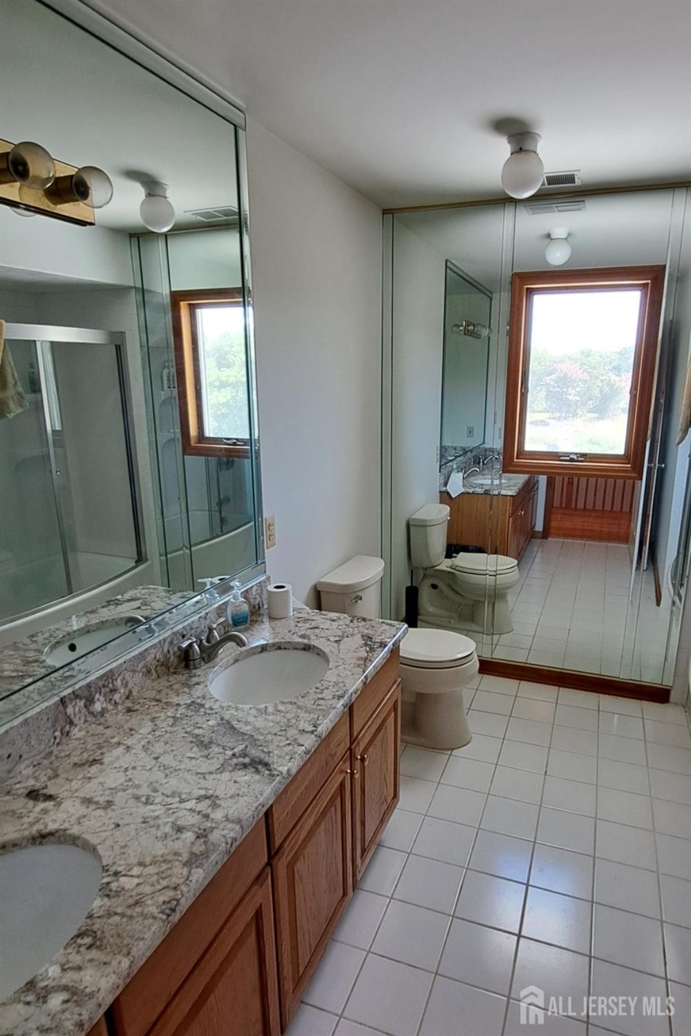 58 Bergen Mills Road Monroe Township, NJ 08831 - Photo 13 of 24 a spacious bathroom with a granite countertop sink and a mirror