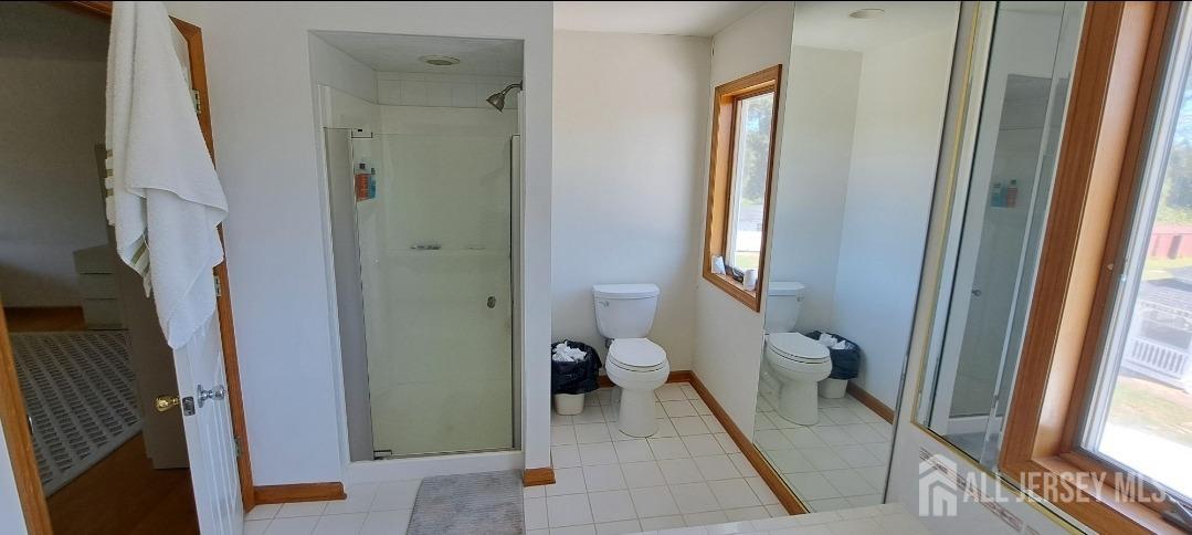 58 Bergen Mills Road Monroe Township, NJ 08831 - Photo 16 of 24 a bathroom with a tub and a glass door