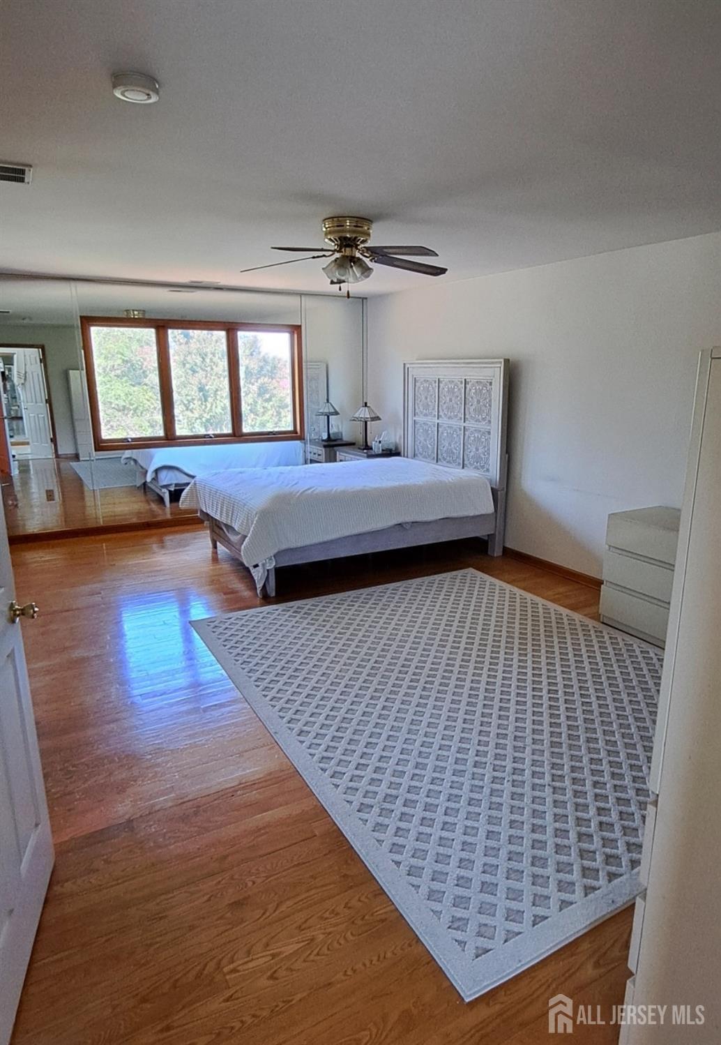 58 Bergen Mills Road Monroe Township, NJ 08831 - Photo 18 of 24 a bedroom with a bed and wooden floor