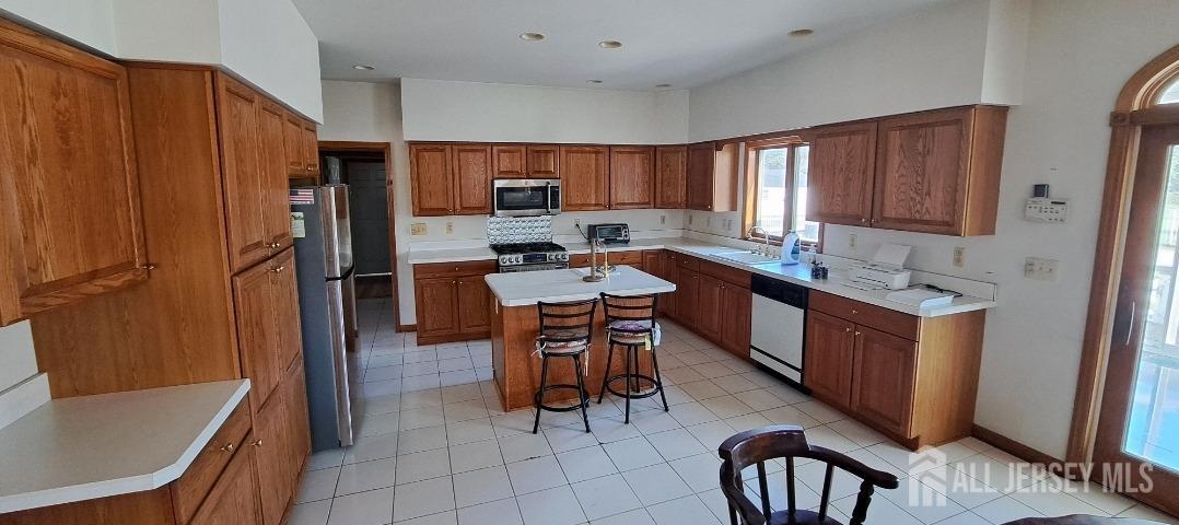 58 Bergen Mills Road Monroe Township, NJ 08831 - Photo 5 of 24 a kitchen with stainless steel appliances granite countertop a sink counter space and a refrigerator