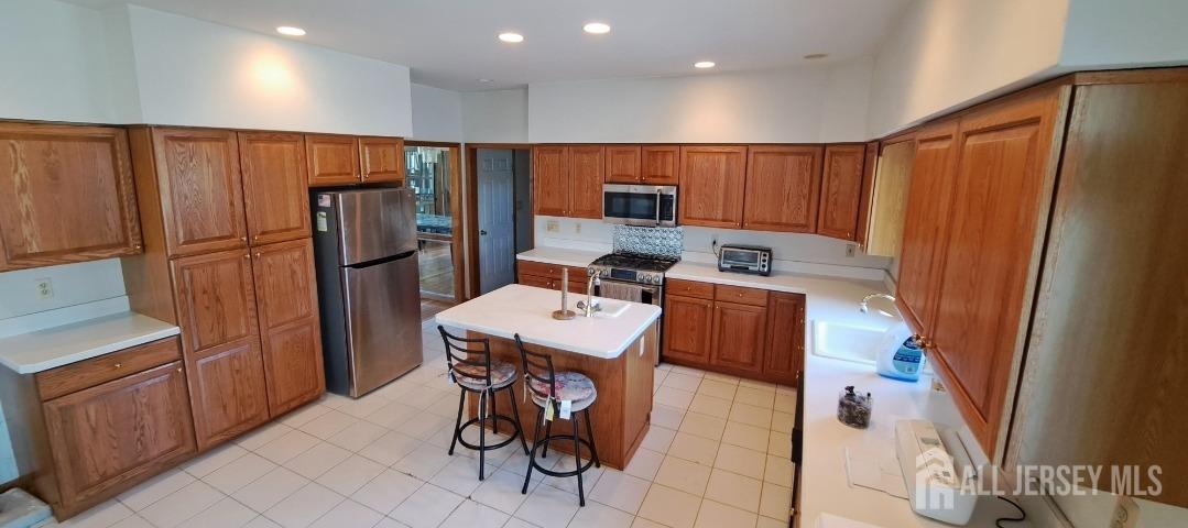 58 Bergen Mills Road Monroe Township, NJ 08831 - Photo 6 of 24 a kitchen with stainless steel appliances a refrigerator and a stove top oven