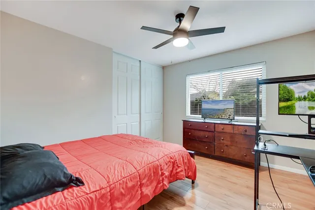 a bedroom with a large bed and a chandelier