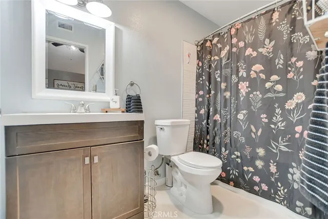 a bathroom with a sink toilet and mirror