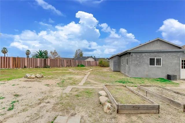 a view of a house with backyard and sitting area