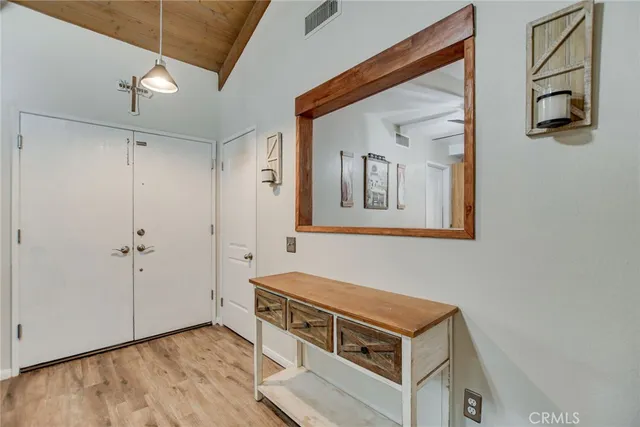 a room with wooden floor and white walls