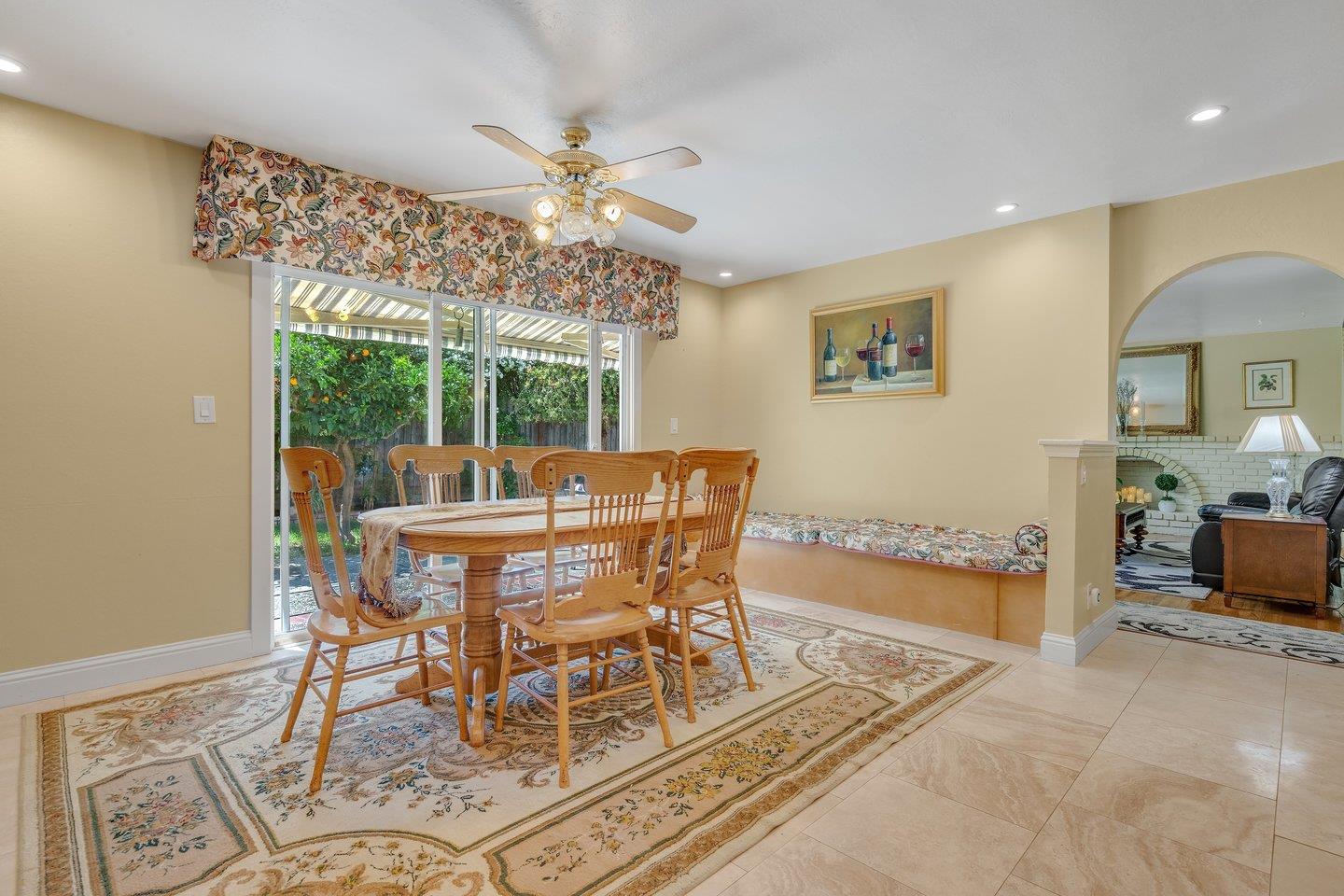 2289 Montezuma Drive Campbell, CA 95008 - Photo 17 of 46 a dining room with furniture a rug a potted plant and a chandelier