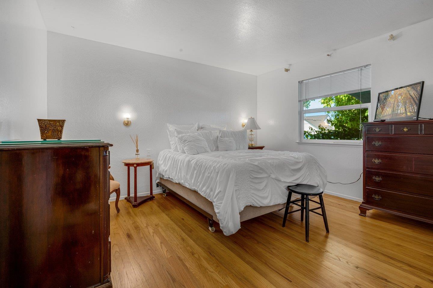 2289 Montezuma Drive Campbell, CA 95008 - Photo 21 of 46 a bedroom with a bed and a dresser with wooden floor