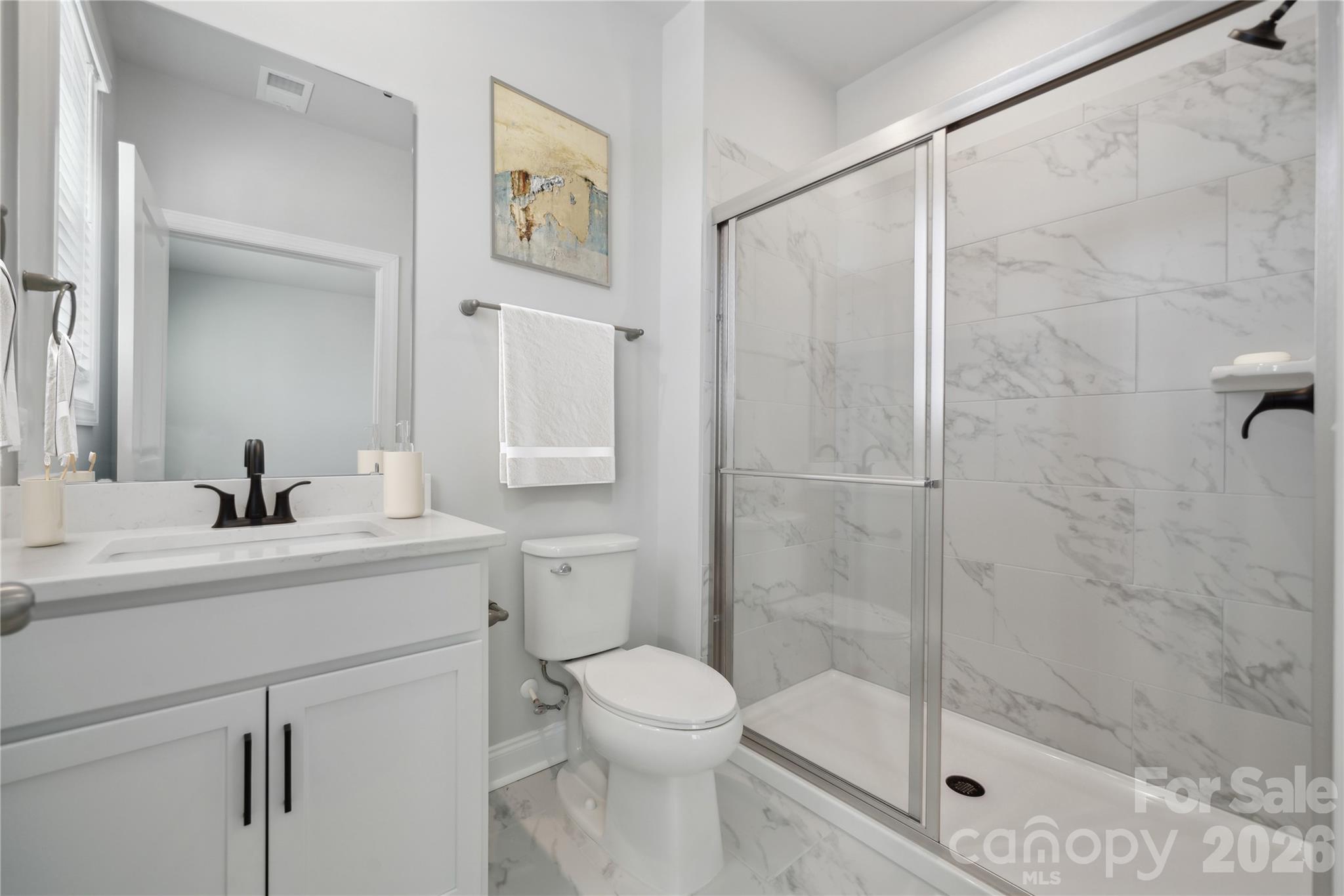 343 Alameda Way Matthews, NC 28104 - Photo 14 of 30 a bathroom with a shower sink vanity mirror and toilet