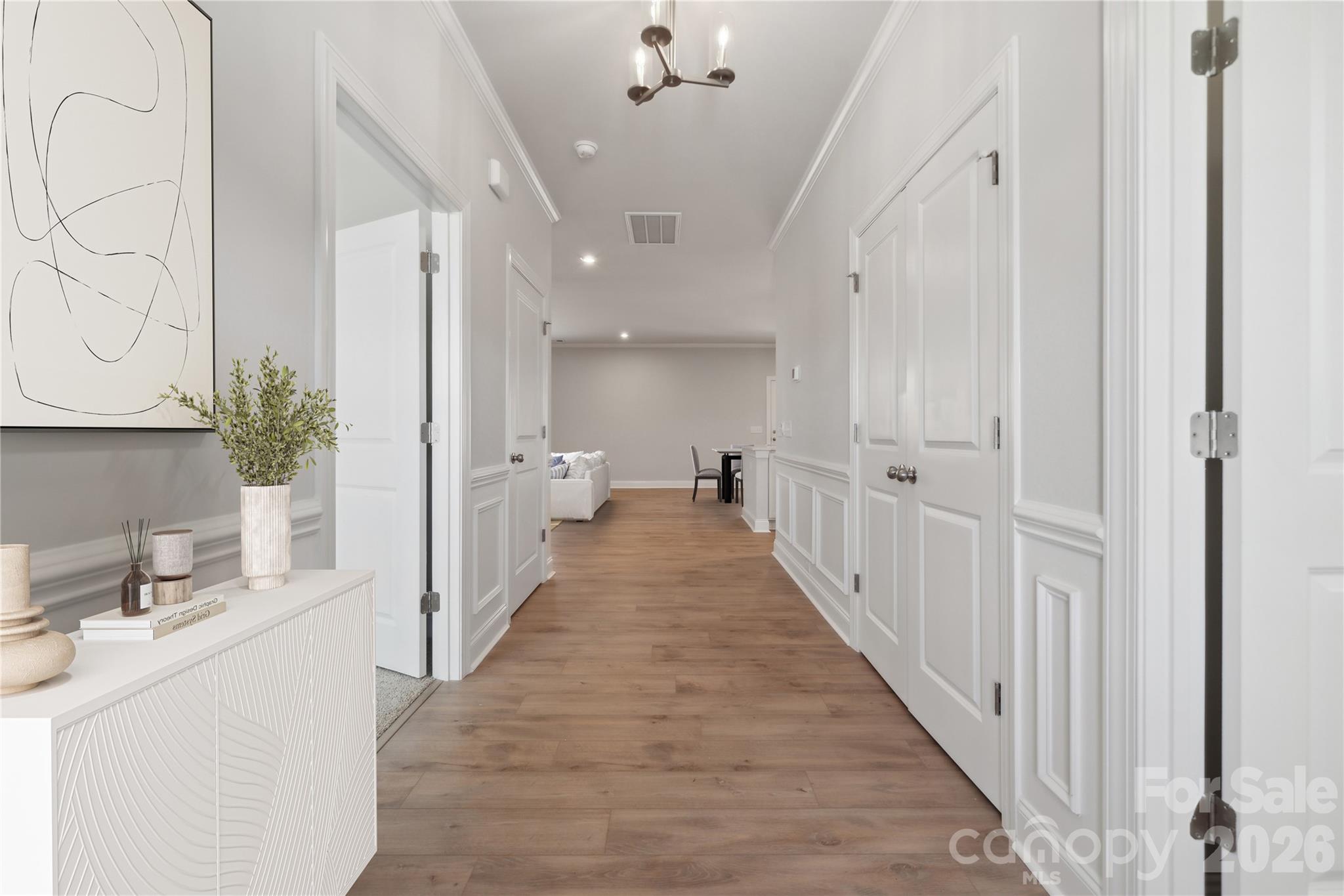 343 Alameda Way Matthews, NC 28104 - Photo 23 of 30 a view of a hallway with a sink and a mirror