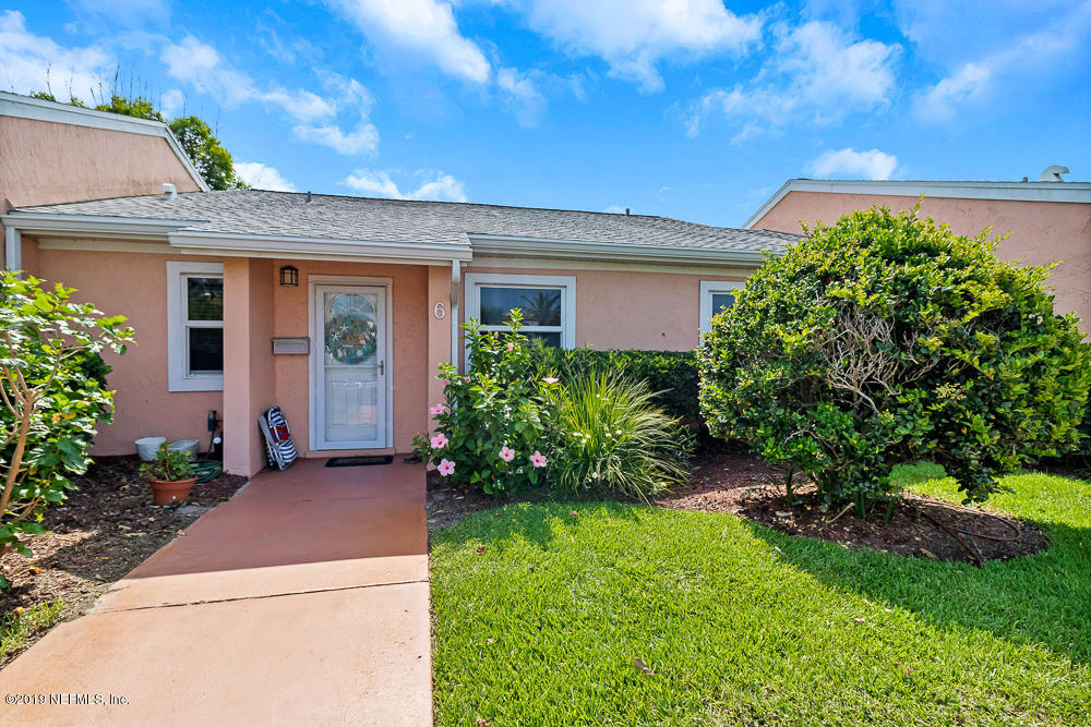 4 Ocean Trace Road, Unit 6 St. Augustine, FL 32080 - Photo 1 of 31 a front view of a house with a garden