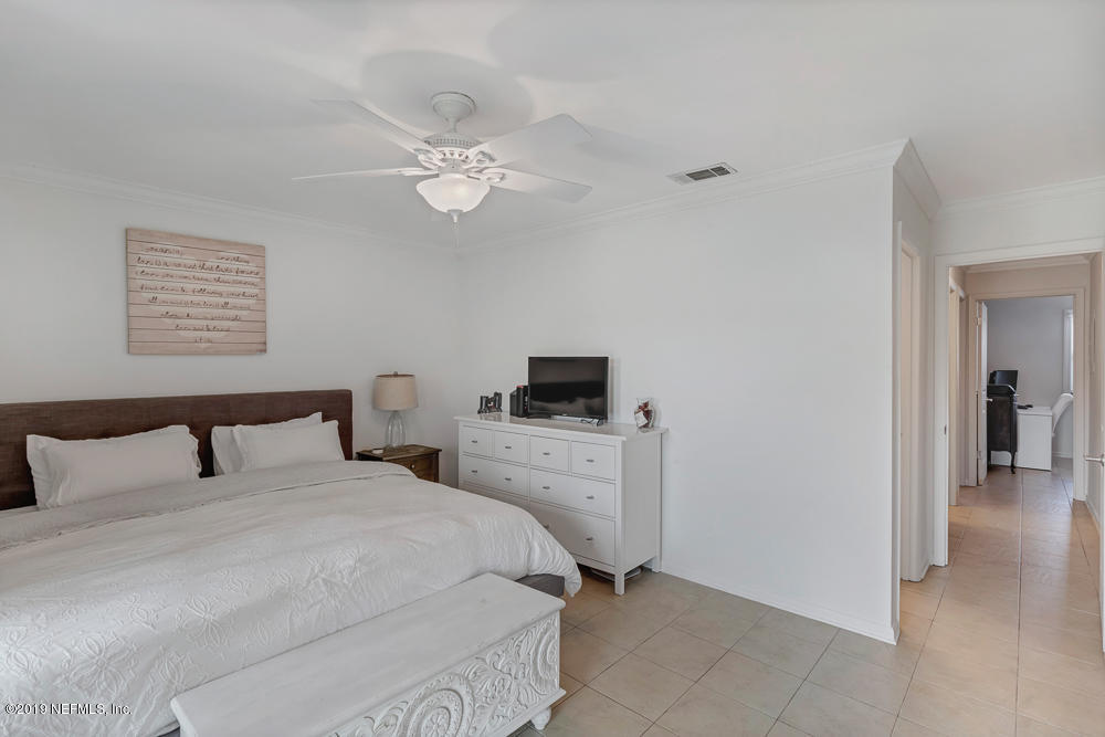 4 Ocean Trace Road, Unit 6 St. Augustine, FL 32080 - Photo 13 of 31 a bedroom with a bed and a tv
