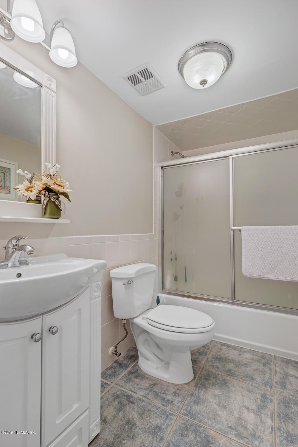 4 Ocean Trace Road, Unit 6 St. Augustine, FL 32080 - Photo 18 of 31 a bathroom with a sink a toilet and shower
