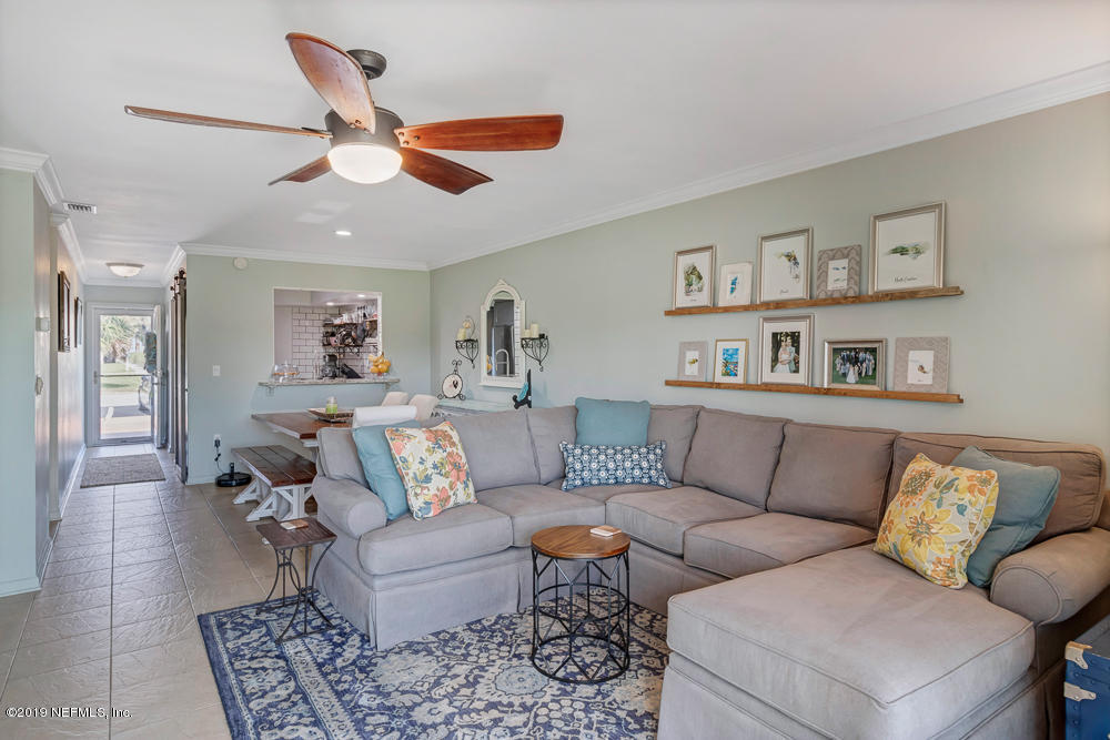 4 Ocean Trace Road, Unit 6 St. Augustine, FL 32080 - Photo 2 of 31 a living room with furniture and a ceiling fan