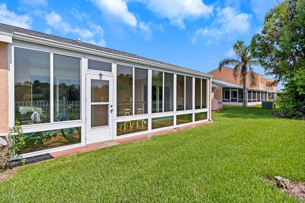 4 Ocean Trace Road, Unit 6 St. Augustine, FL 32080 - Photo 26 of 31 a view of a house with a yard and sitting area