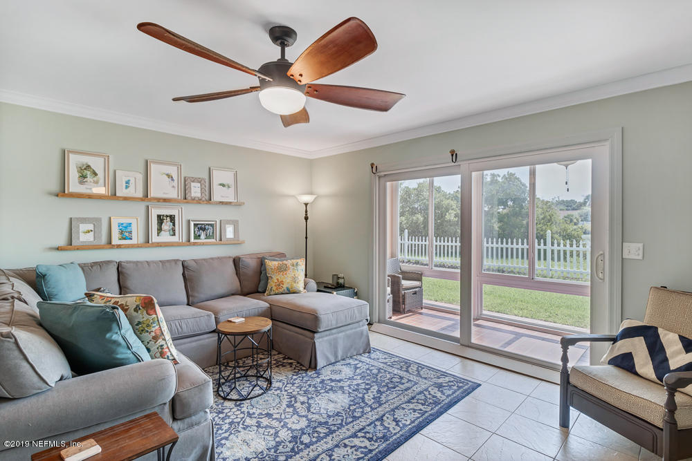 4 Ocean Trace Road, Unit 6 St. Augustine, FL 32080 - Photo 3 of 31 a living room with furniture and a large window